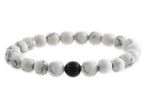 Detail view of minimalist white howlite stone beaded bracelet with single black round bead.
