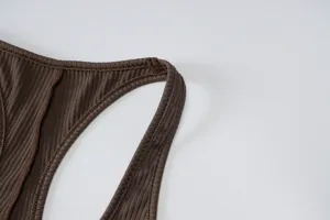 Detail view of brown ribbed knit activewear jumpsuit strap, soft stretchy fabric fitness.