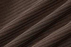 Close-up fabric detail of women's ribbed knit yoga jumpsuit showing fine vertical texture.