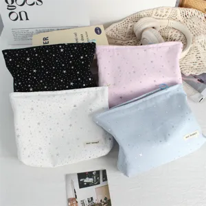 Detail view of the star sequin cosmetic pouch, showing sparkly silver prints and fine fabric texture.