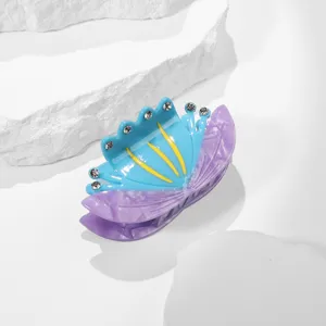 Acetate hair claw clip with blue flower purple butterfly design and sparkling rhinestones.