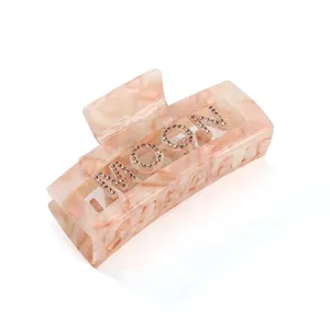 Molla per capelli in acetato con lettere MOON in strass, elegante accessorio per donne.