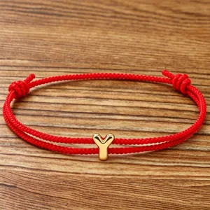 Red string braided bracelet with golden letter Y charm for couples and daily lucky wear.