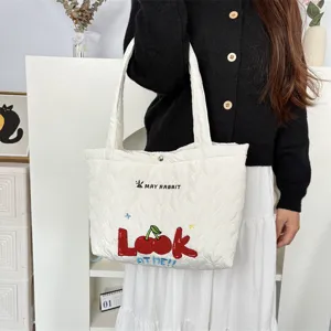Quilted heart shoulder bag detail featuring cute embroidered cherry and letters for women.