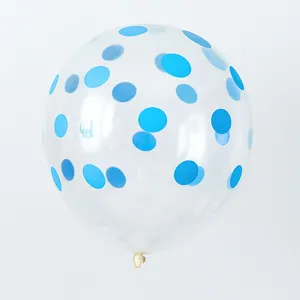 Close-up of a transparent latex balloon filled with vibrant blue round confetti pieces