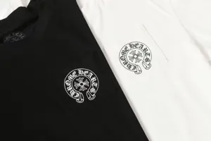 Close-up detail of gothic horseshoe logo printed on black and white t-shirt pockets