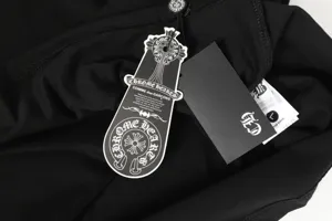 Close-up of Chrome Hearts tags on premium black cotton t-shirt