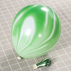 Detail view of green marble pattern latex balloon showing inflated and uninflated states
