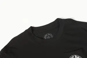 Close-up of a black cotton t-shirt collar featuring a horseshoe brand logo print inside.