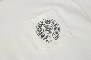 Detailed macro shot of a white pocket T-shirt featuring a black horseshoe graphic print.