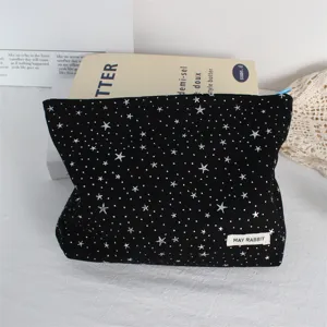 Black cosmetic bag with silver stars, portable large capacity makeup storage pouch for daily use.