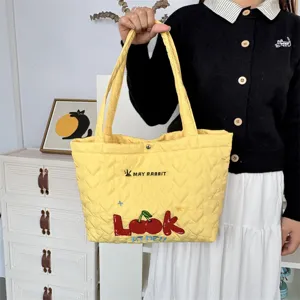 Yellow quilted tote bag with cute cherry embroidery and shoulder straps for daily shopping.