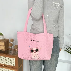 Pink quilted heart pattern tote bag detail, cute pig embroidery, casual shoulder carry.