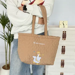 Bruine gewatteerde hartshopper detail met schattige eendenborduursel en ruime tas.