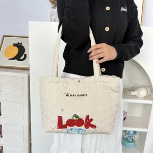 Quilted heart tote bag with cute cherry embroidery and shoulder straps for casual shopping.