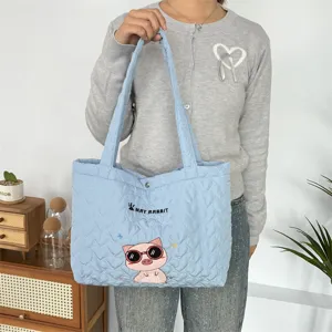 Light blue quilted tote bag with cute pig embroidery, soft casual shoulder bag for daily commute.