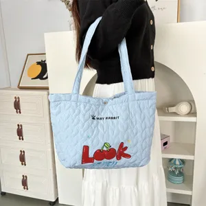 Detailed view of the cute quilted heart shoulder bag with cherry embroidery for women shopping.