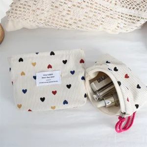 Corduroy cosmetic bag large capacity portable storage pouch with colorful heart prints.