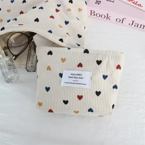 Cute corduroy cosmetic bag with colorful heart print, portable zipper pouch, detail view.