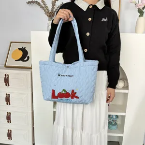 Details of the light blue quilted shoulder tote bag with cute cherry embroidery design.