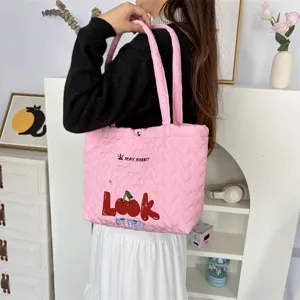 Pink quilted tote bag with cute cherry embroidery and heart pattern for casual daily shopping.