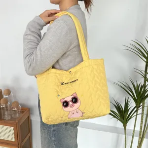 Yellow quilted tote bag with cute pig embroidery, casual large capacity shoulder bag for daily use.