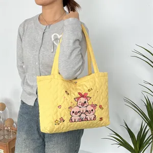 Yellow quilted tote bag featuring cute pig embroidery, casual large capacity shoulder bag.