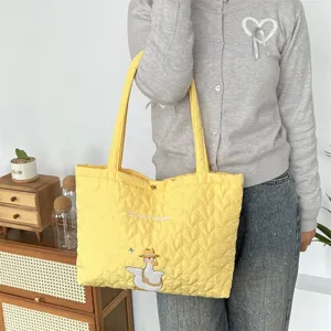 Cute yellow quilted tote bag with heart pattern and adorable duck embroidery for women daily commute.