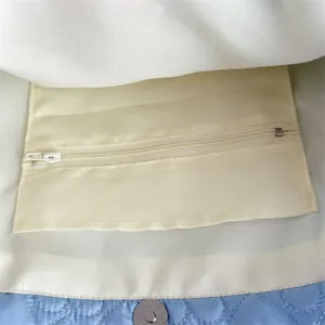 Detailed view of the quilted tote bag interior featuring zipper pocket and magnetic snap.