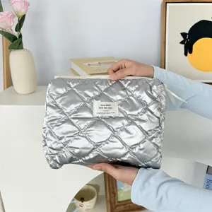 Silver quilted cosmetic bag, portable waterproof makeup pouch with large capacity for daily use.