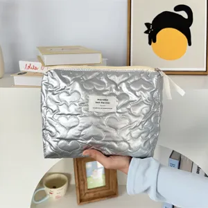 Silver quilted heart cosmetic bag detail showing soft PU texture and cute design.
