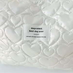 White PU quilted heart clutch bag, soft glossy waterproof cosmetic and travel storage pouch.