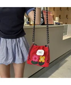 Red canvas crossbody phone bag featuring cute embroidered flowers and drawstring closure.