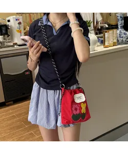 Fashionable small red floral crossbody phone bag with cute embroidered flowers and strap.