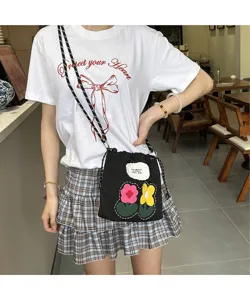 Fashionable ins style black canvas mobile phone bag with cute embroidered flowers and strap.