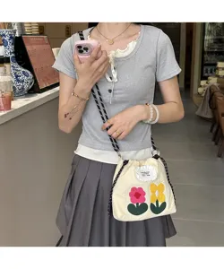 Canvas floral crossbody phone bag with drawstring and cute embroidered flowers for daily use.