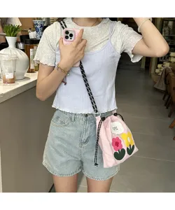 Casual canvas phone bag with cute embroidered flower patches and stylish crossbody strap.