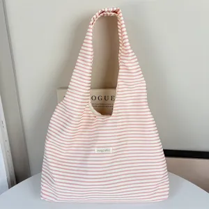 Detailed view of the pink and white striped shoulder bag, lightweight canvas grocery tote.