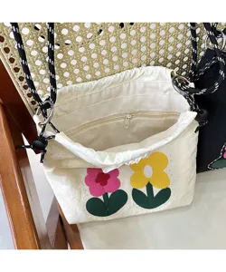 Cute canvas mobile phone bag with sweet floral embroidery, drawstring closure and crossbody strap.