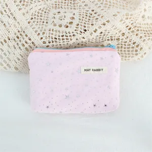 Closeup detail of pink canvas pouch featuring sparkling silver stars and cute zipper.