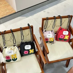 Cute floral canvas drawstring phone bag for women, stylish crossbody pouch with embroidered flowers.