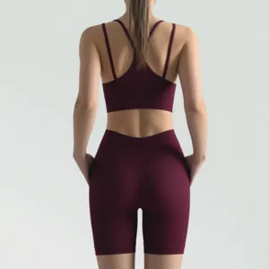 Ribbed sports bra and shorts detail view in dark red showing cross back straps and fit.