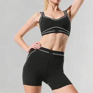 Women color block yoga set sports bra and fitness shorts for running and gym workouts.