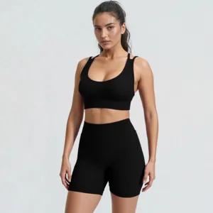 Close-up detail of the black ribbed yoga set featuring a supportive sports bra and active shorts.