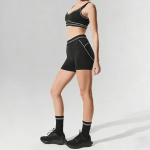 Black sports bra and shorts yoga set detail, contrast piping fitness activewear outfit.