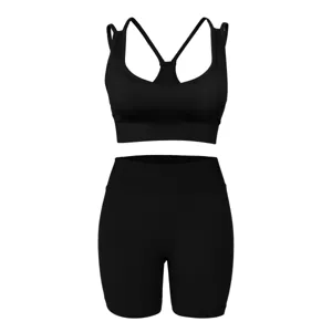Black ribbed activewear set detail view, featuring a supportive sports bra and high-waist shorts.