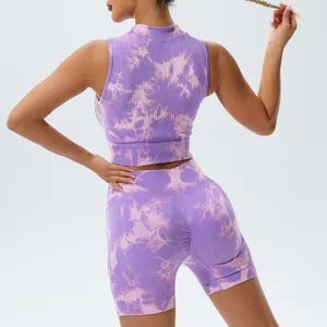 Back view of purple tie-dye seamless yoga crop top and shorts, ribbed activewear detail.