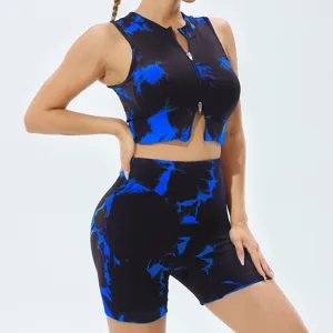 Close-up detail view of women tie dye fitness yoga set crop top and shorts activewear.