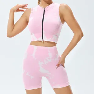 Pink tie-dye fitness set featuring a sleeveless zippered crop top and high waist shorts.