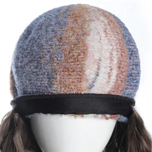 Detail view of the rainbow oil painting knit beret with attached long wavy synthetic hair.